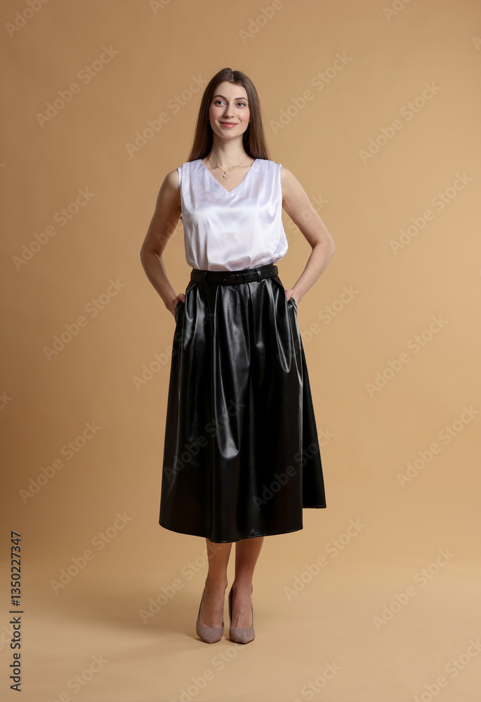 Fototapeta premium Beautiful woman in stylish outfit on beige background