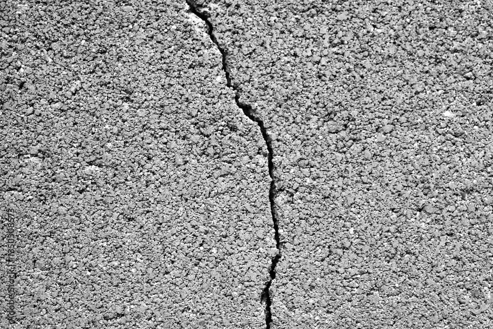 Obraz premium Dirty cracked cinder brick block concrete wall with gravel stones texture background. Old rough and grunge texture wall. Texture of cement wall.