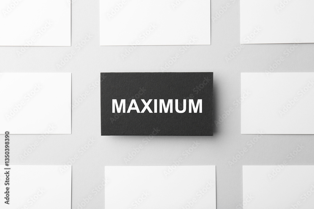 Black business card with word Maximum among empty white ones on light background, flat lay Black business card with word Maximum among empty white ones on light background, flat lay