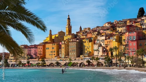 Colourful houses, palm trees on the embankment in Menton, Provence, Alps, Cote d'Azur France February 26, 2025. High quality 4k footage