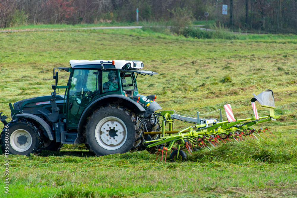 Obraz premium Tractor with Tedder in the Field