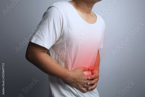 Wallpaper Mural A man in a white shirt gestures about having a stomachache. Torontodigital.ca