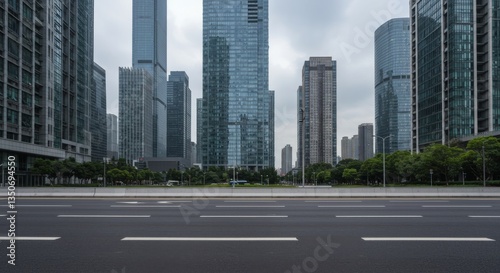 Modern city buildings line a highway under a cloudy sky