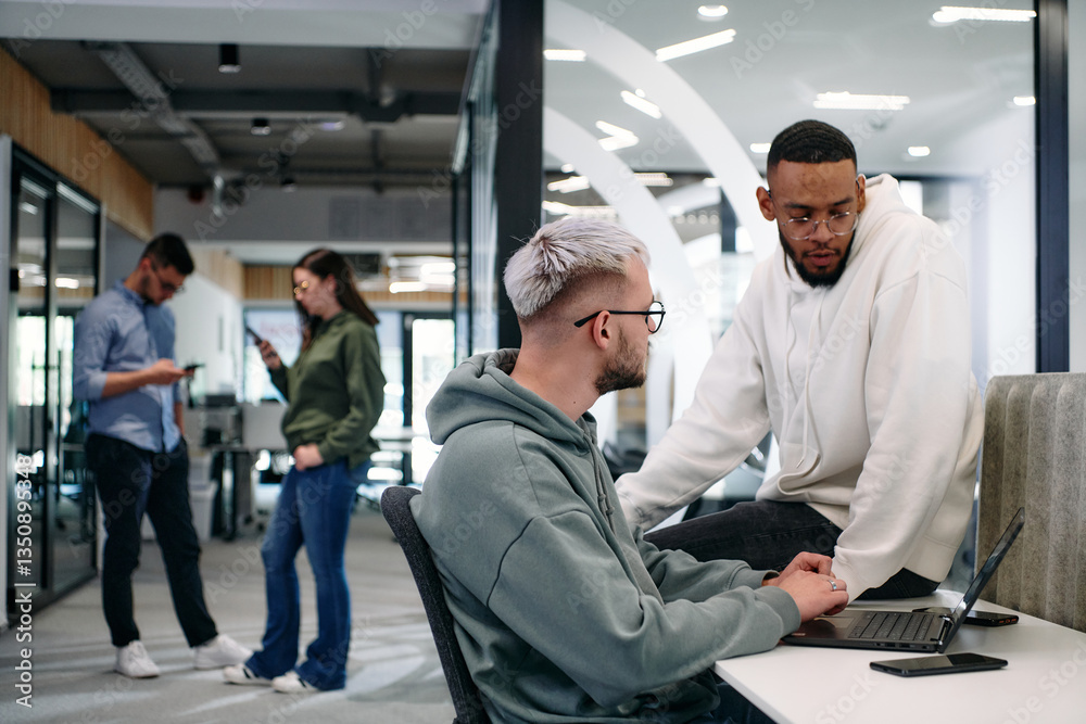 Young group of business people brainstorming together in a startup space, discussing business projects, investments, and solving challenges.