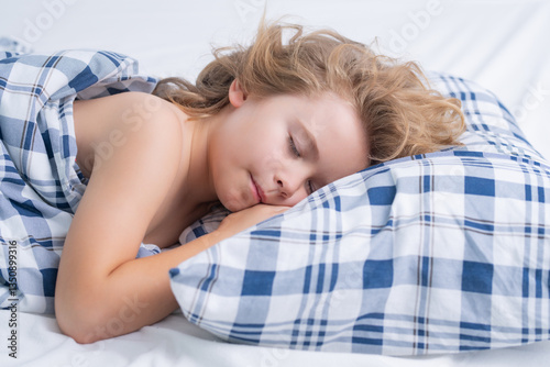 Good morning sleep. Little kid sleeps on bed, napping. Cute child sleeping. photo