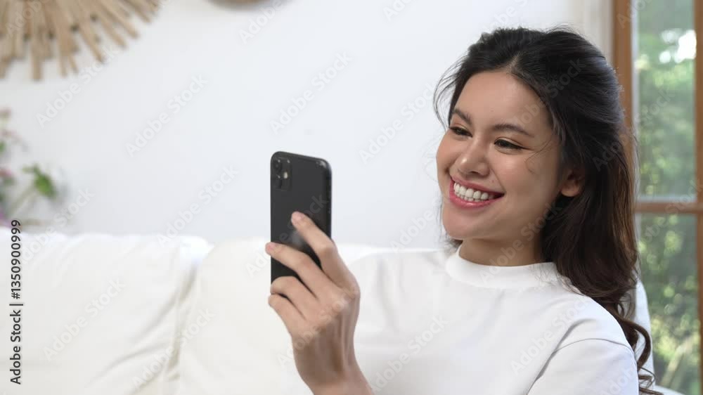 Young woman using smartphone browsing for online shopping E commerce by online payment gateway at vivancy home. Modern and convenience online purchasing make secure and convenient purchases. Young woman using smartphone browsing for online shopping E commerce by online payment gateway at vivancy home. Modern and convenience online purchasing make secure and convenient purchases.
