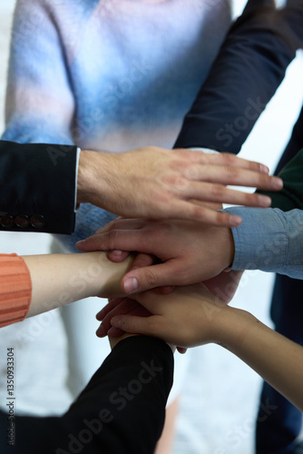 Wallpaper Mural A top view of business people joining hands in a circle, symbolizing unity, collaboration, and shared success in the workplace Torontodigital.ca