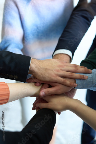 Wallpaper Mural A top view of business people joining hands in a circle, symbolizing unity, collaboration, and shared success in the workplace Torontodigital.ca