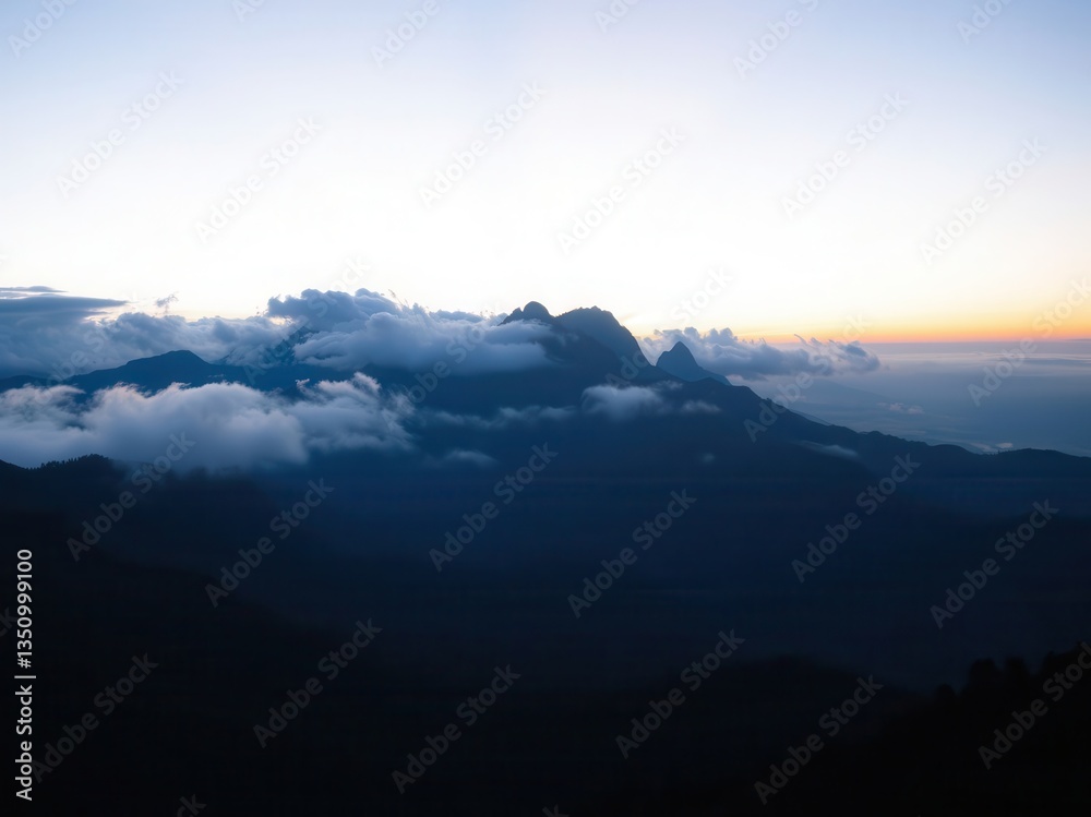 Fototapeta premium Sunrise over Cloud Covered Mountains