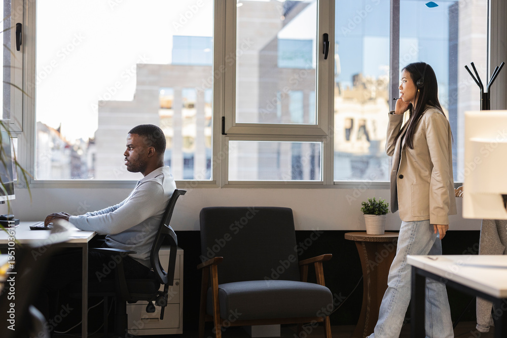 Businesspeople working in modern office with city view