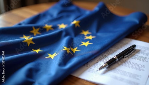 A European Union flag with golden stars on a blue background rests elegantly on a document, symbolizing Europe Day's celebration of peace, unity, and shared European values photo