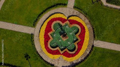 Flowerbed.
A flowerbed with a pattern of flowers. Taken by a drone from above. Slow takeoff with rotation. 