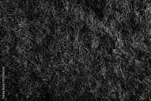 Detailed close up image showing the texture of a dark rug