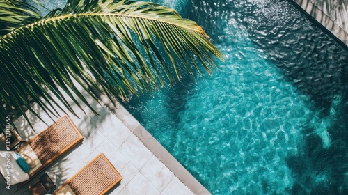 A chic outdoor lounge by the pool, with a palm tree swaying beside clear turquoise water, creating a modern and relaxing summer vibe.