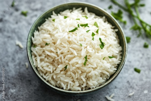 A fresh serving of cooked white rice with chopped herbs garnish photo