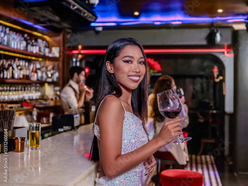 Woman is holding a glass of red wine. Bar, Restaurant and beverage, Night club concept.