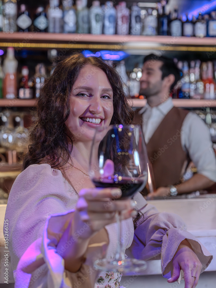 Woman is holding a glass of red wine. Bar, Restaurant and beverage, Night club concept.