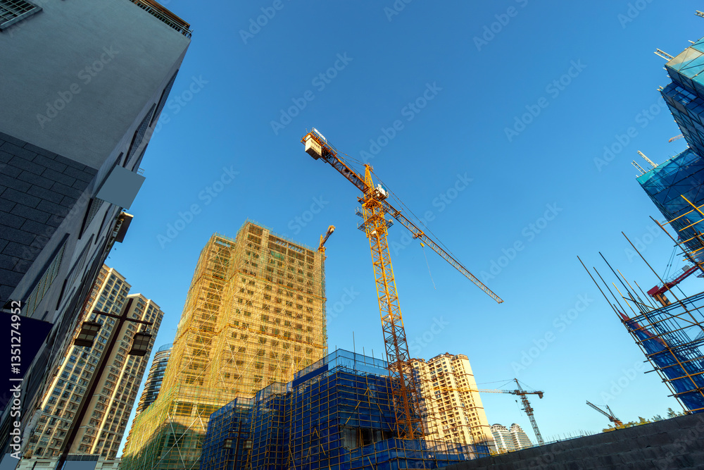 Building construction site, tall skyscrapers and cranes.