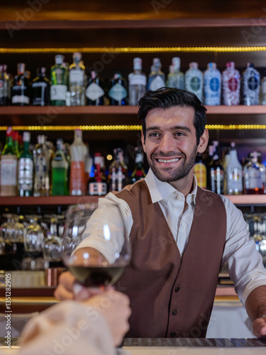 Obraz na płótnie Bartender giving glass of wine to woman customer at bar counter . w salonie