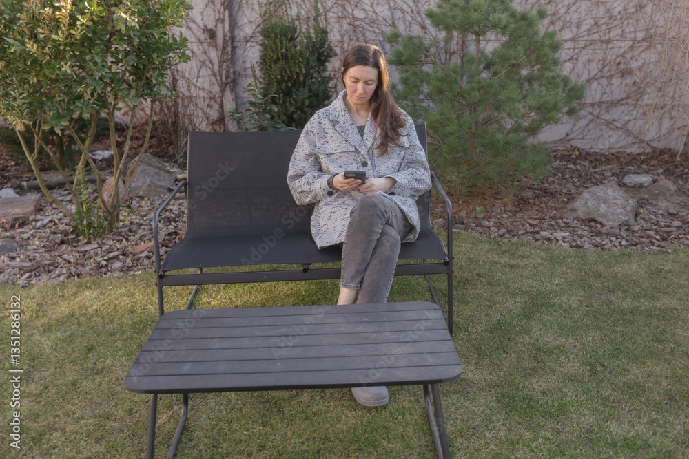 Fototapeta premium Woman using phone outdoors