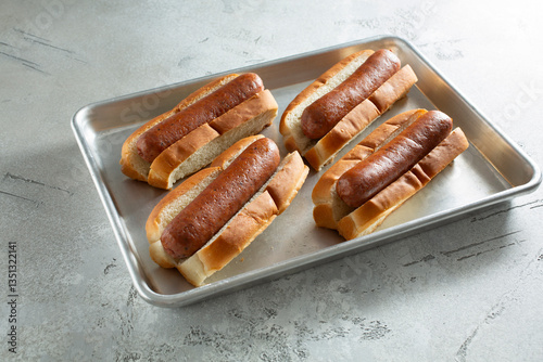 A view of a baking tray of turkey hot dogs.