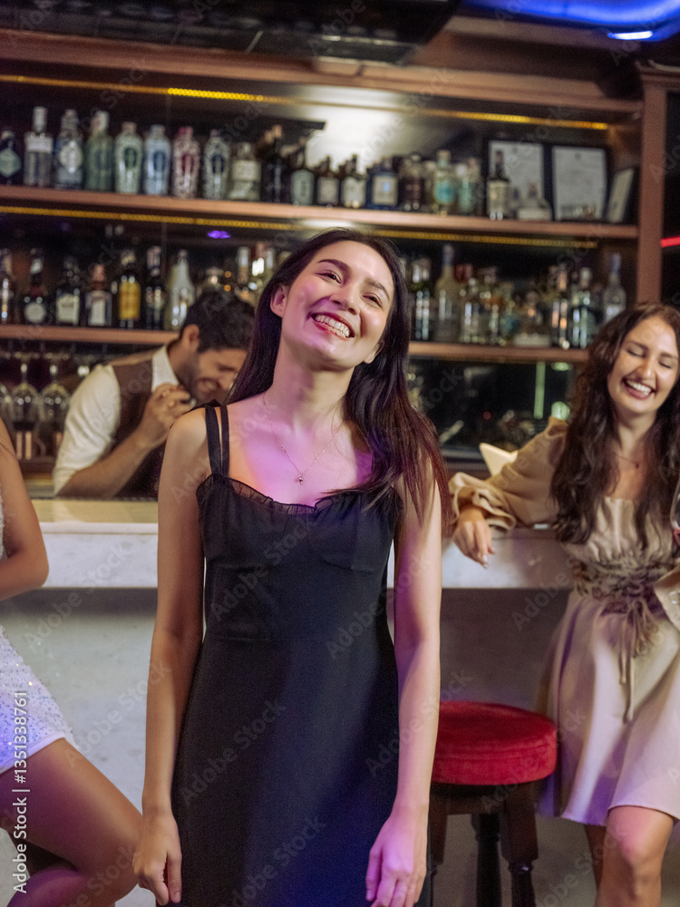 Group of young people dancing happily in night life in a pub, restaurant, bar. Concept, relax, holiday.