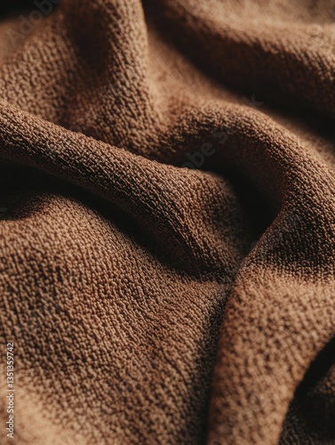 A close-up shot of a brown blanket on a bed, perfect for interior design and home decor photoshoots