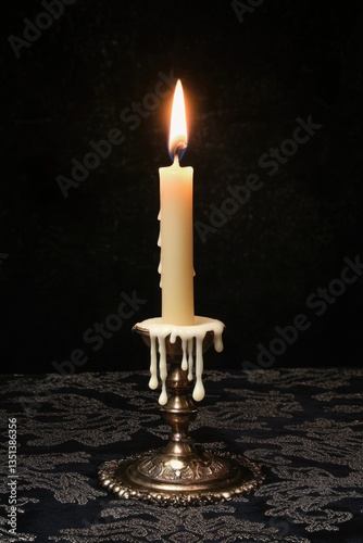 A single lit candle placed on a table, ready for use