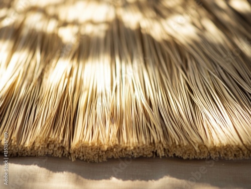 Obraz na płótnie A close-up view of a straw umbrella on a table, perfect for everyday use or as a decorative item w salonie