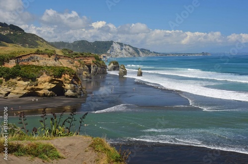 looking down on  three sisters rock formations and spectacular tongaporutu coastline on a sunny summer day from south pilot road viewpoint south of moaku, on west coast of north island of new zealand 