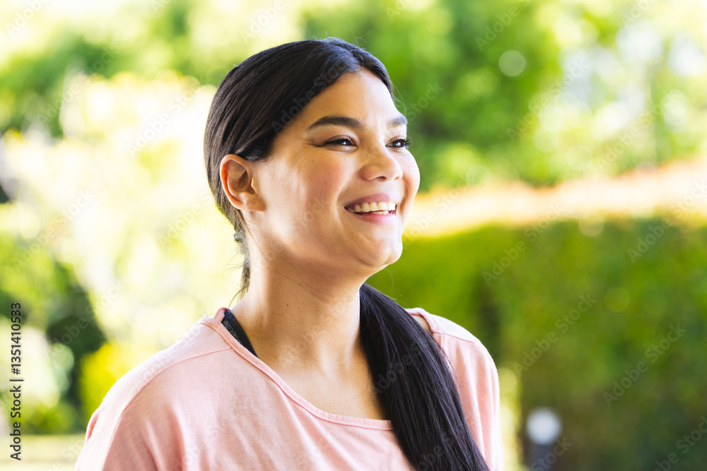 Smiling woman enjoying outdoor time in garden, feeling relaxed and happy Smiling woman enjoying outdoor time in garden, feeling relaxed and happy