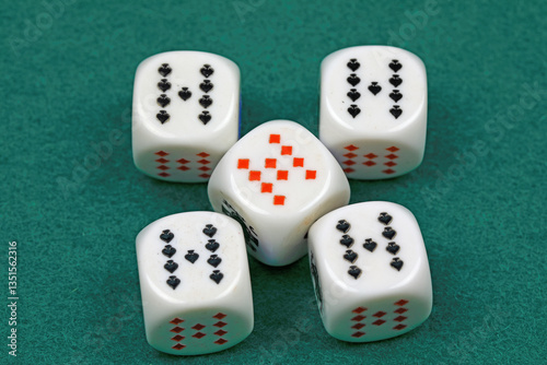 White dice for the game, that have been rolled on a green cloth