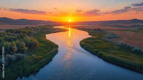 The glorious sunset reflects beautifully in the flowing river and its banks