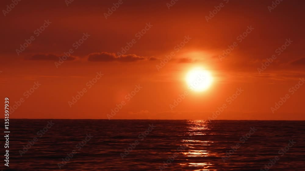 Breathtaking orange sunset over the sea, with vibrant hues of orange and reflecting on calm waves. Perfect for themes of serenity, travel, and natural beauty. Sunset over the water in slow motion Breathtaking orange sunset over the sea, with vibrant hues of orange and reflecting on calm waves. Perfect for themes of serenity, travel, and natural beauty. Sunset over the water in slow motion