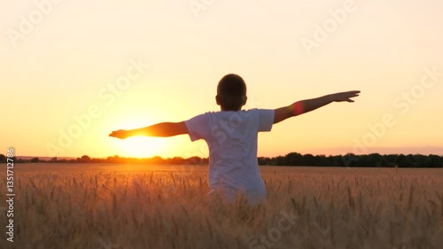 Happy male teen running on wheat field with open hands enjoy freedom at sunset sunrise back view closeup. Boy kid teenager relaxing imagine flying at dusk rye meadow sun sky forest horizon