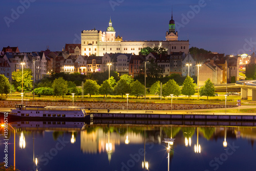 Obraz na płótnie Oder River waterfront in Szczecin Poland with illuminated buildings and docked boats before sunrise w salonie