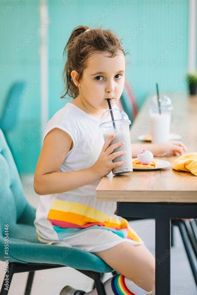 Cute girl drinking milkshake in cafe and having fun. Retro style. Cute girl drinking milkshake in cafe and having fun. Retro style.