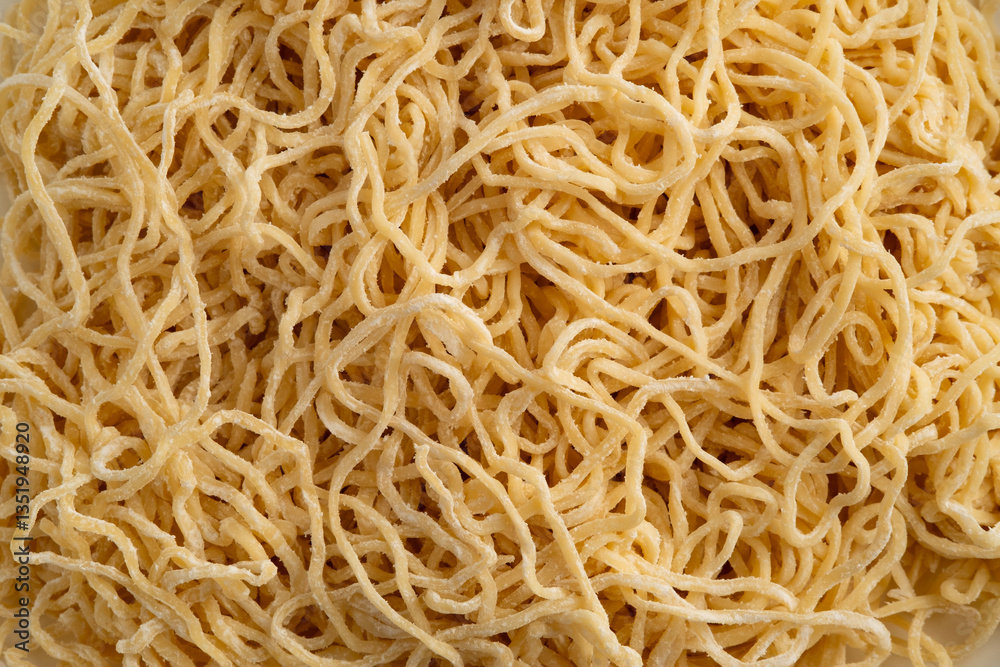 Chinese egg noodle,Thin yellow noodles covered by flour for texture background