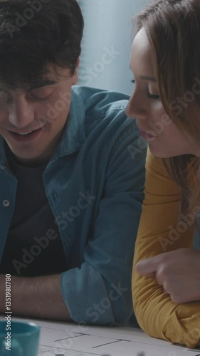 Young couple working on their new house project. Vertical video