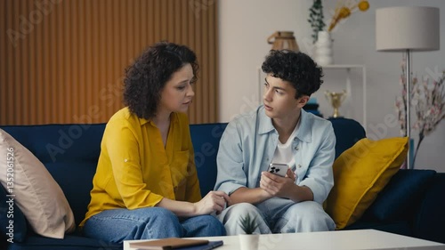 Wallpaper Mural Teen son helping his mother with a new phone app, fixing gadget issues together Torontodigital.ca