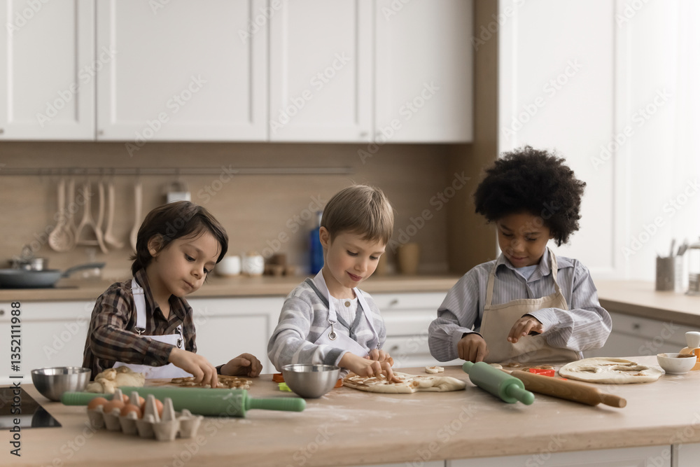 Cooking kids. Multiethnic group of three happy little boys preschool age friends enjoy easy baking make family style cookies with simple recipe cut different pastry shapes from rolled dough with molds Cooking kids. Multiethnic group of three happy little boys preschool age friends enjoy easy baking make family style cookies with simple recipe cut different pastry shapes from rolled dough with molds