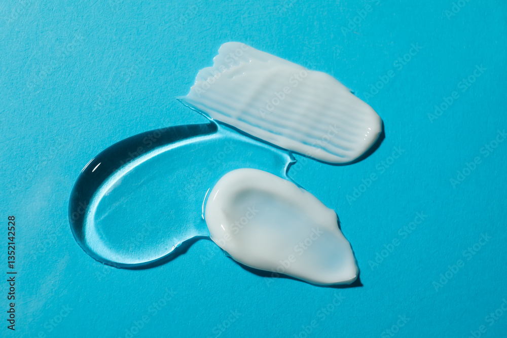 Fototapeta premium Body cream and gel on light blue background, flat lay