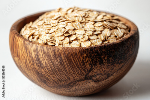 Wooden bowl filled with oats, surrounded by fresh berries, nuts, and a drizzle of honey, set on a rustic table in soft morning light.