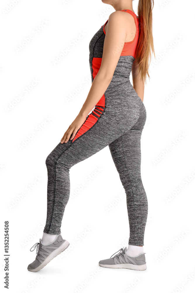 Fototapeta premium Young woman in sportswear on white background