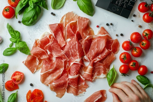 Delicious Cured Ham With Fresh Tomatoes and Basil Arranged on a Countertop Pr...