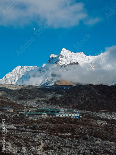 Himalayan village with snow peaks and moon