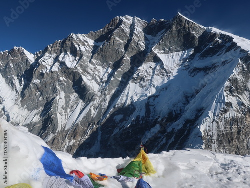 Snowy Himalayan peak with prayer flags from the top of Island peak