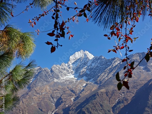Rocky foreground and mountain peaks under clear sky