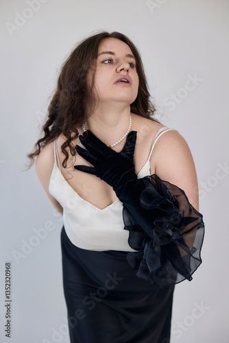 Elegant and emotional portrait of a glamorous woman in chic black and white attire with pearls and gloves, ideal for fashion, beauty, luxury branding, and artistic projects.