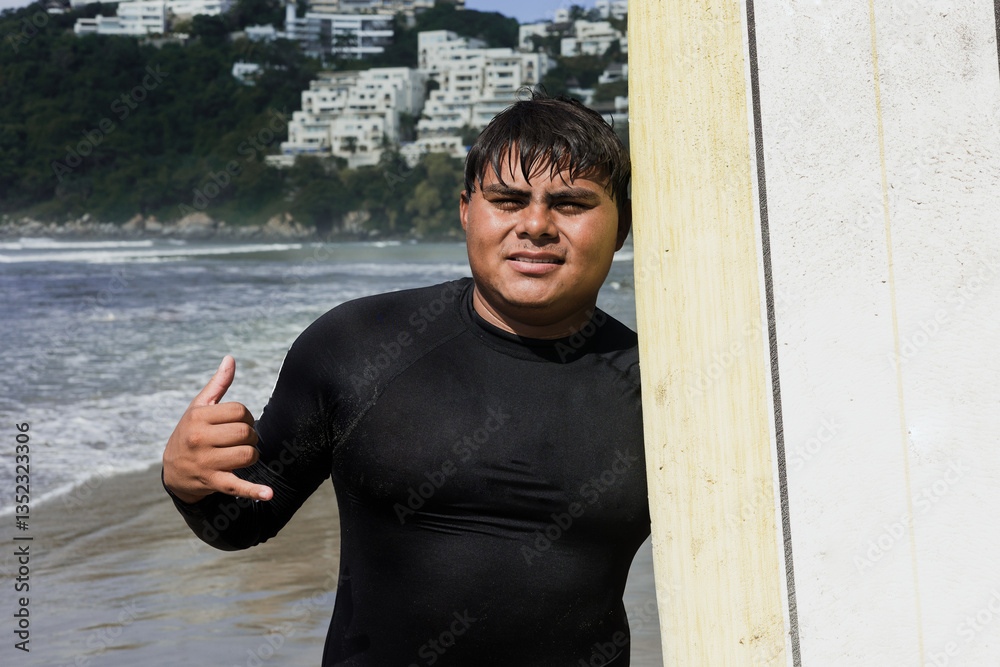 Naklejka premium portrait of latin surfer man rides the tropical waves in Mexico Latin America, hispanic people surfing in summer sport activity